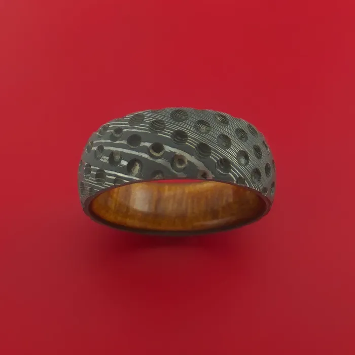 Damascus Steel Ring with Milled Golf Ball Dimple Inlay and Interior Hardwood Sleeve Custom Made Band Lashbrook Rings Damascus Steel Ring with Milled Golf Ball Dimple Inlay and Interior Hardwood Sleeve Custom Made Band Lashbrook Rings