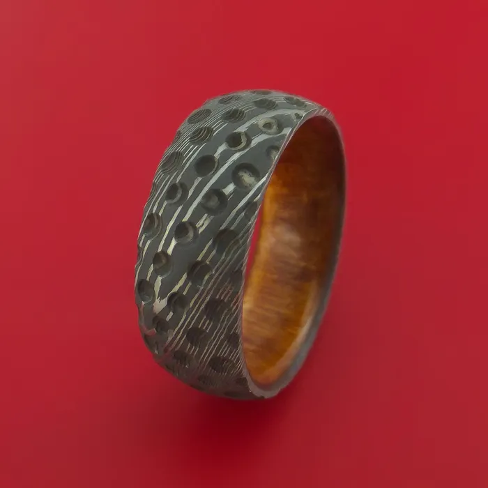 Damascus Steel Ring with Milled Golf Ball Dimple Inlay and Interior Hardwood Sleeve Custom Made Band Lashbrook Rings Damascus Steel Ring with Milled Golf Ball Dimple Inlay and Interior Hardwood Sleeve Custom Made Band Lashbrook Rings